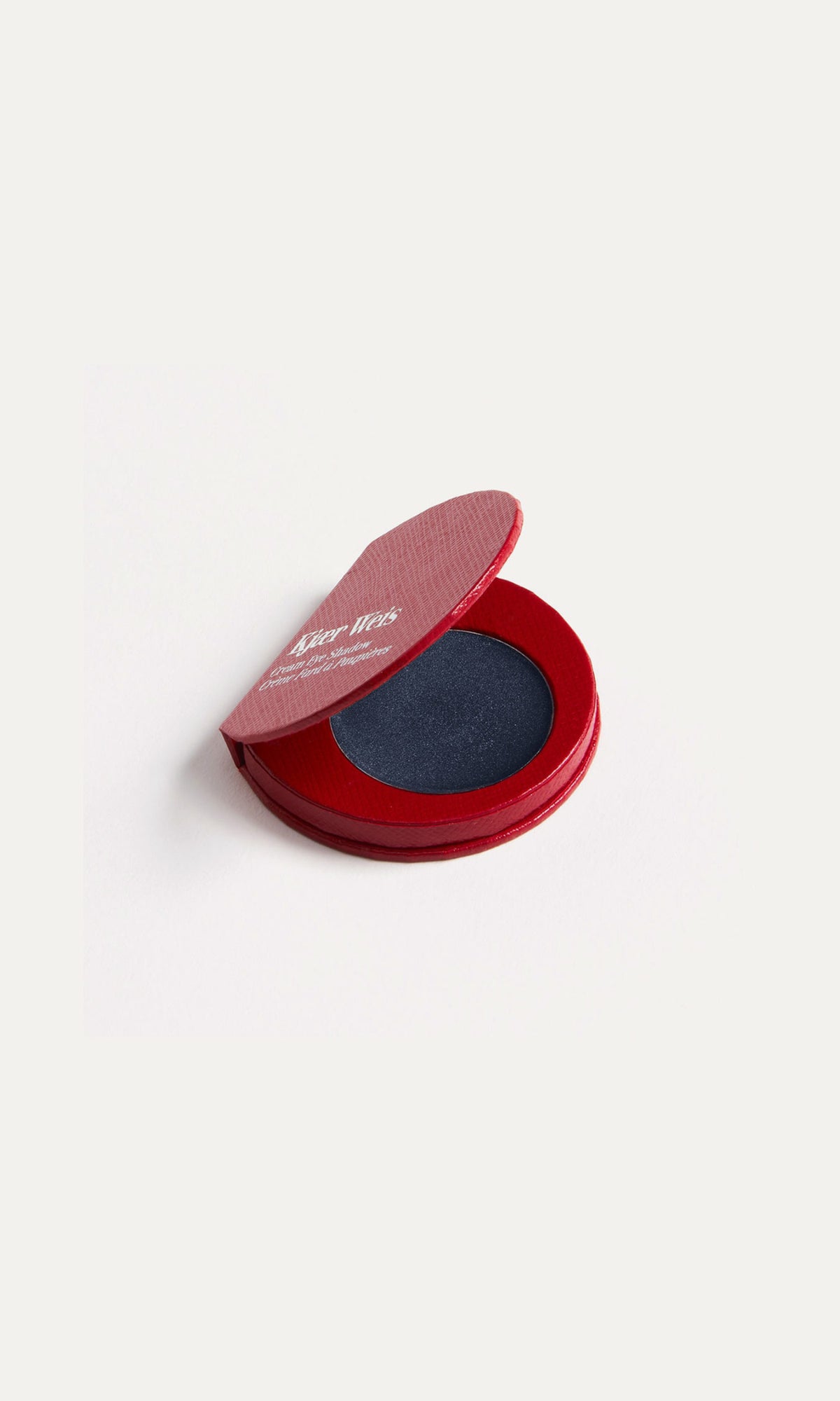 Red compact with blue eyeshadow on a white background