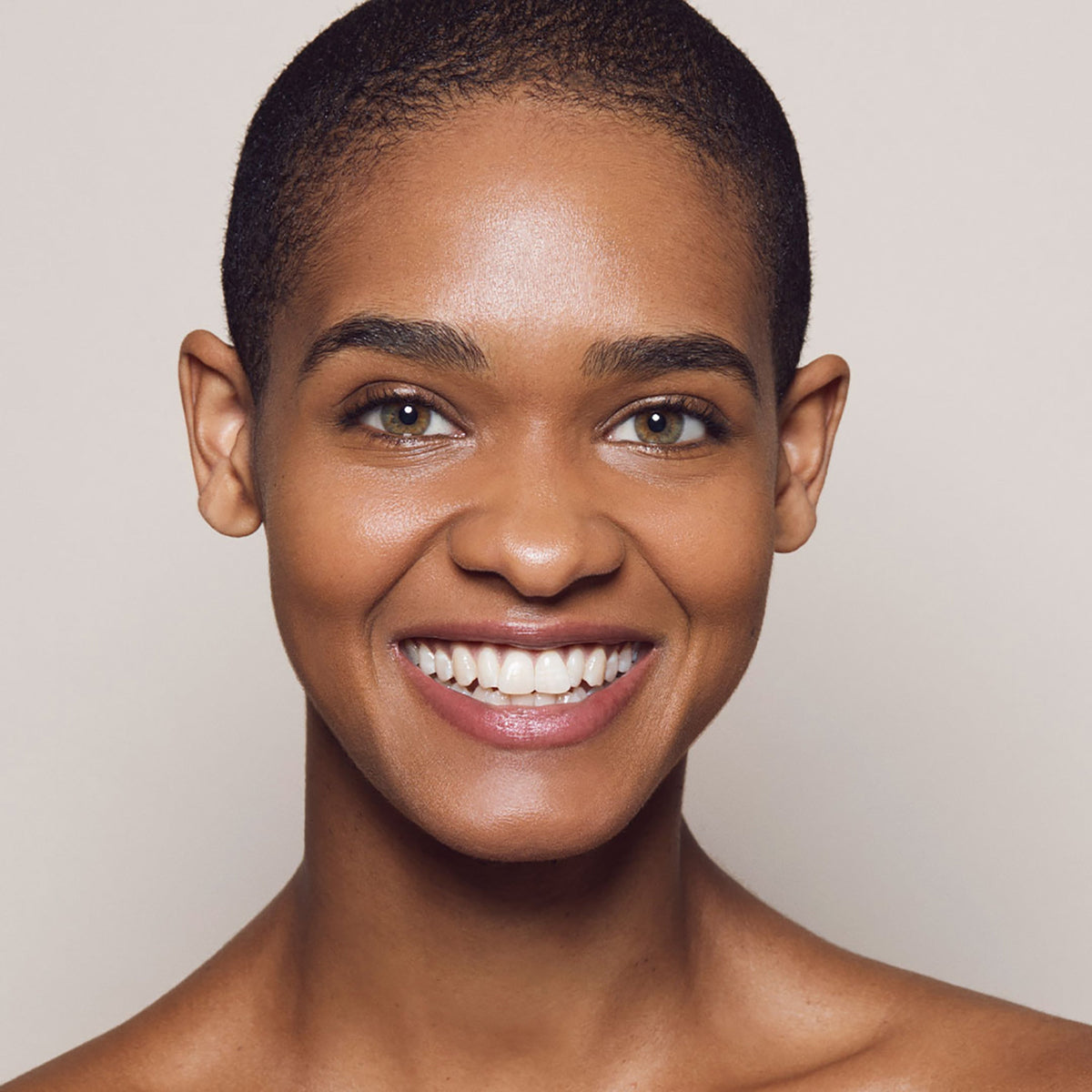 Close up of person’s face with tan, warm-toned skin