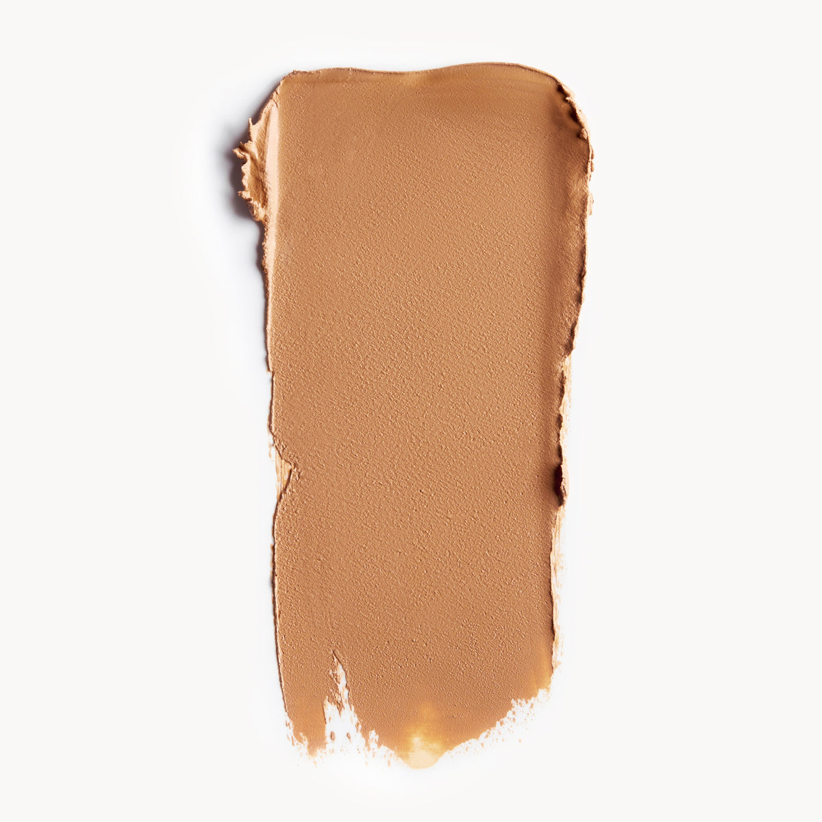 A wipe of medium, warm-toned cream foundation on a white background
