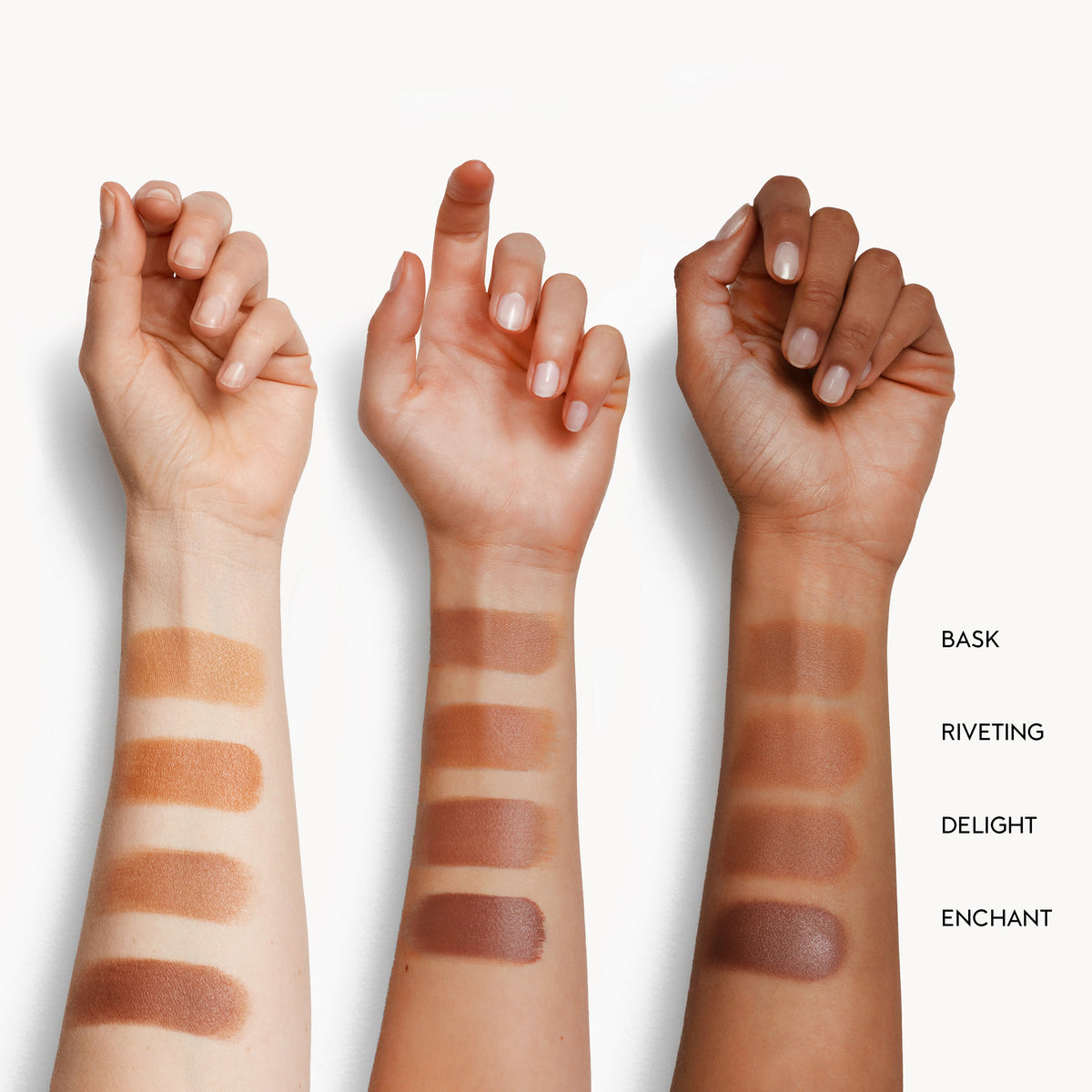 Three arms with different skin tones displaying Kjaer Weis Cream Bronzer swatches in 'Bask', 'Riveting', 'Delight', and 'Enchant'.