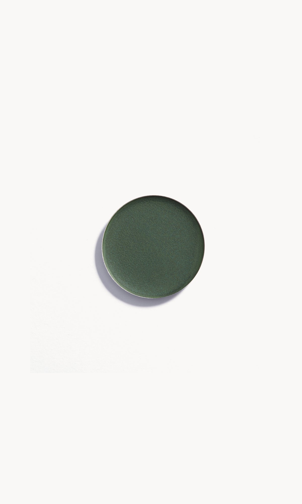 Refill pan of the Kjaer Weis Cream Eye Shadow in the shade Sublime, a dark, moody green velvet.