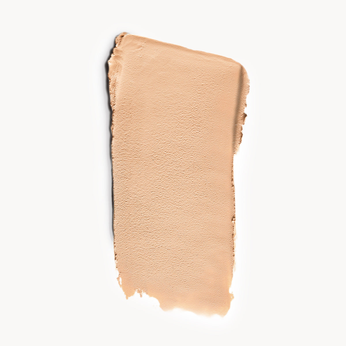 A wipe of fair, neutral-toned cream foundation on a white background
