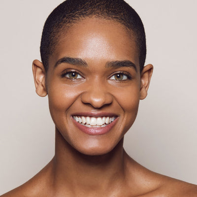 Close up of person’s face with tan, warm-toned skin