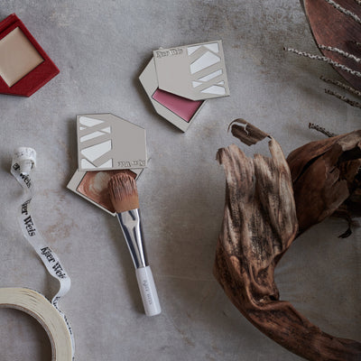Kjaer Weis cream cheek makeup products, including Cream Blush and Cream Bronzer in Iconic Edition cases, Cream Glow in Red Edition compact, and the Blush-Foundation Brush.