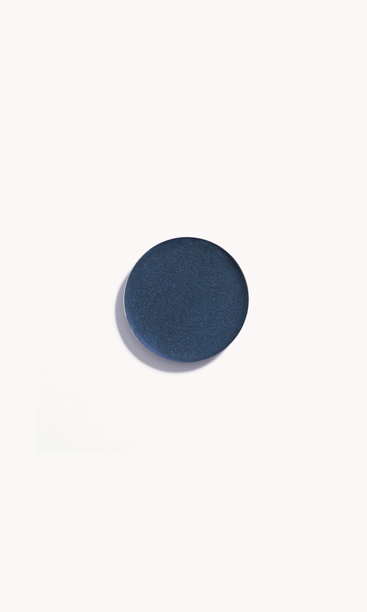 Refill pan of the Kjaer Weis Cream Eye Shadow in the shade Enticing, a versatile deep blue velvet.