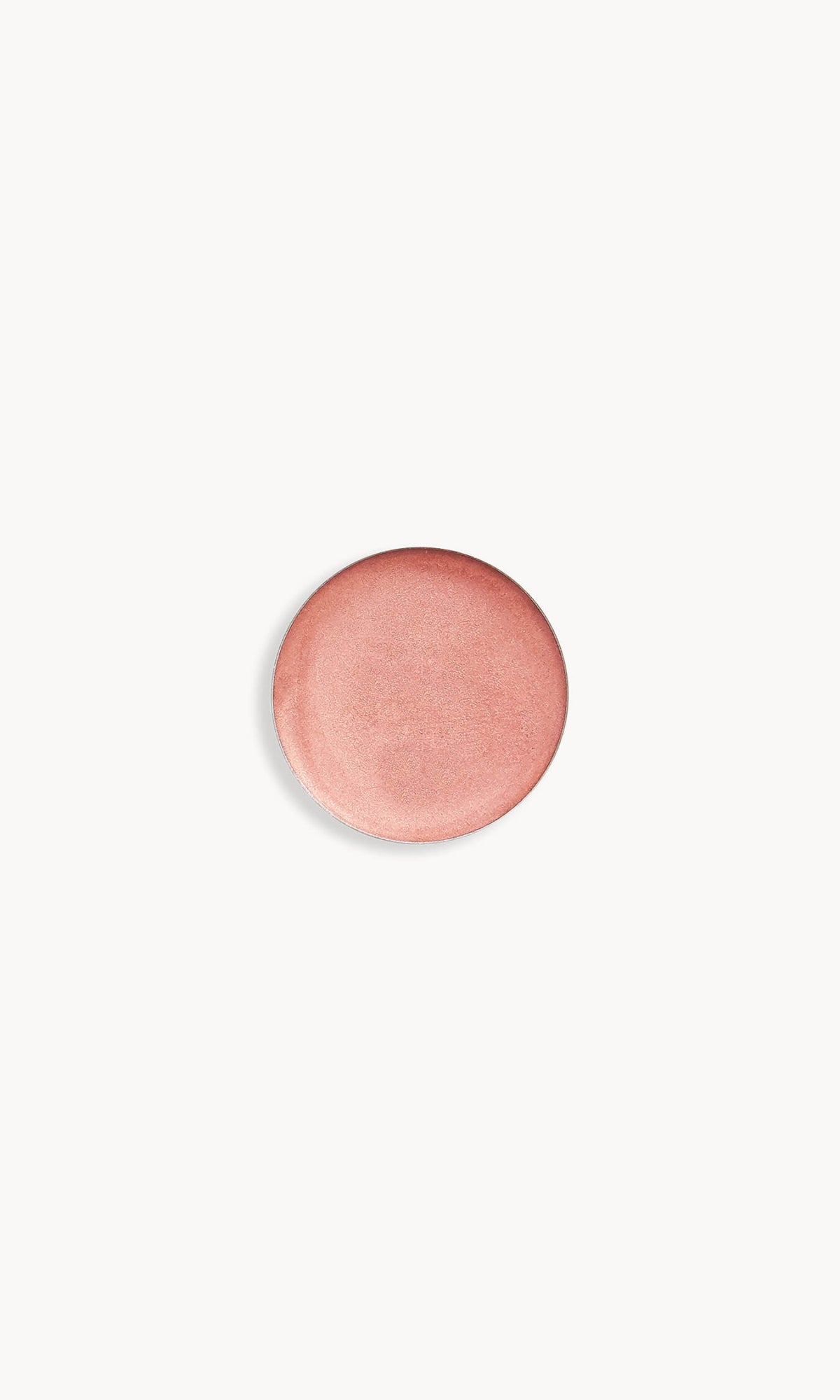Refill pan of the Kjaer Weis Cream Eye Shadow in the shade Illuminated, an iridescent rose gold color.