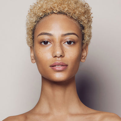 Close up of a person’s face with warm tan skin