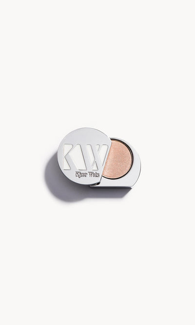 Solid metal KW palette with lid open to show light ivory eye shadow inside